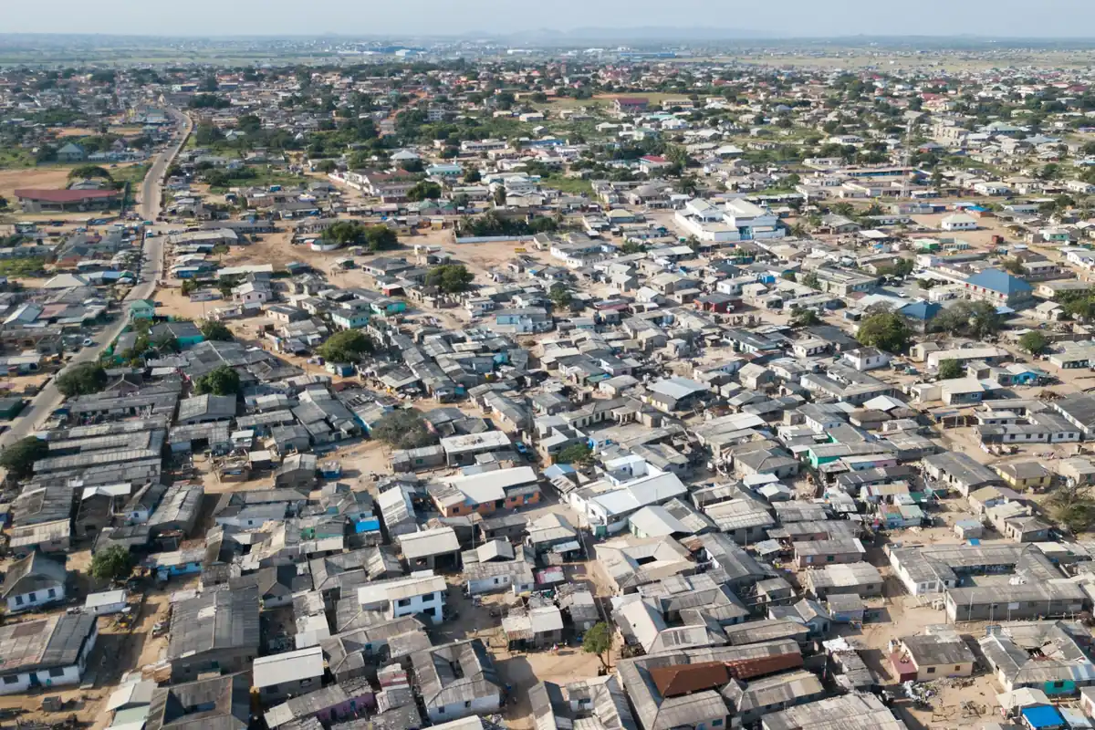 Rooftops of a Ghanaian coastal town stretching towards the horizon